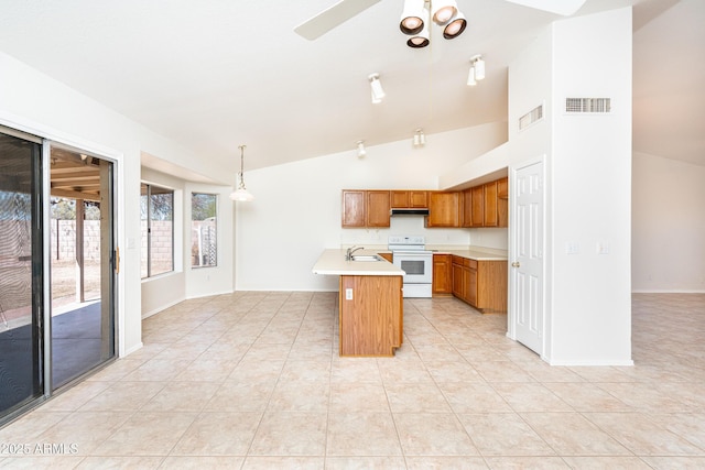 kitchen with visible vents, white electric stove, light countertops, and a sink