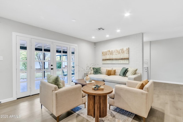 living room with light hardwood / wood-style floors and french doors