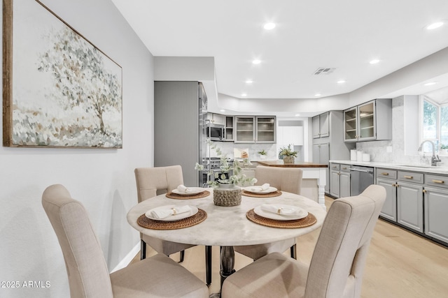 dining area featuring sink and light hardwood / wood-style flooring