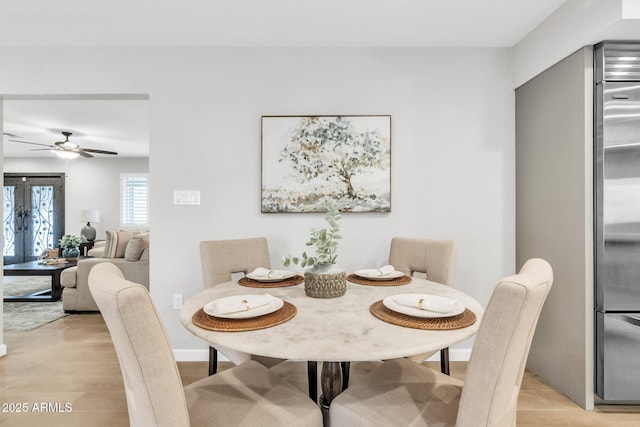 dining area with light wood-type flooring, french doors, and ceiling fan