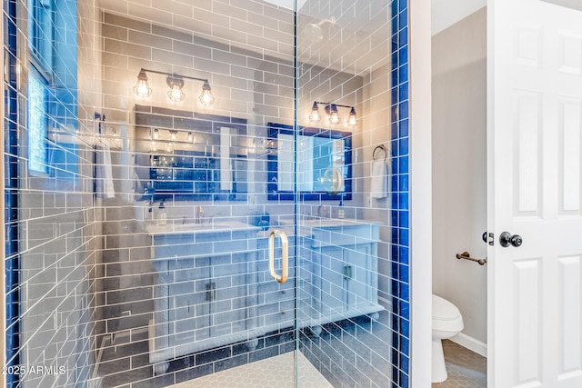 bathroom featuring a shower with door, tile patterned flooring, and toilet