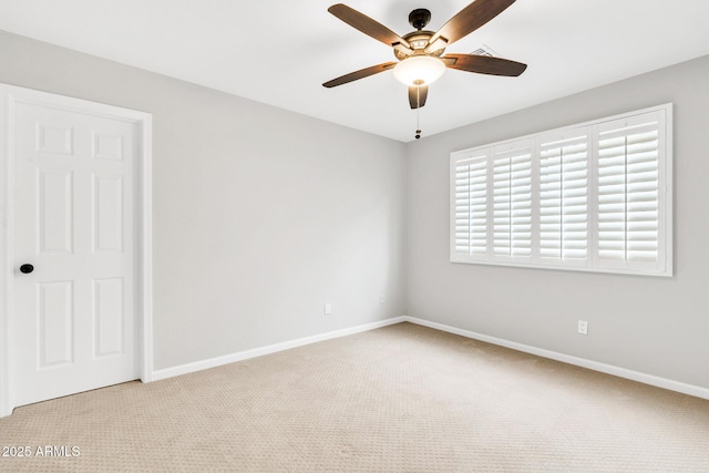 empty room with ceiling fan and light colored carpet