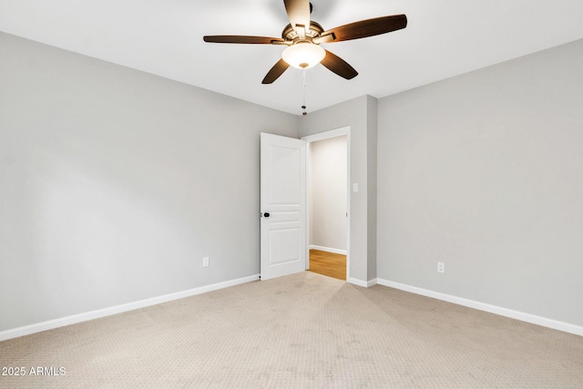 empty room with ceiling fan and light carpet