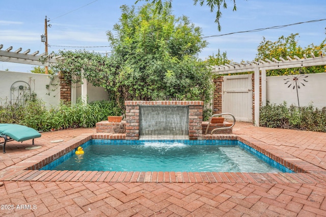 view of pool featuring pool water feature, a pergola, and a patio