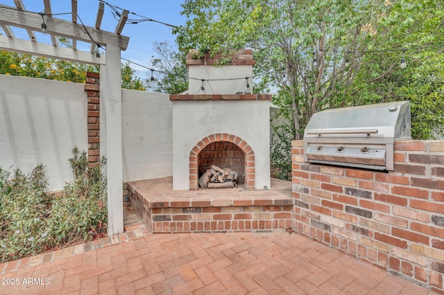 view of patio / terrace with an outdoor kitchen, grilling area, and an outdoor brick fireplace