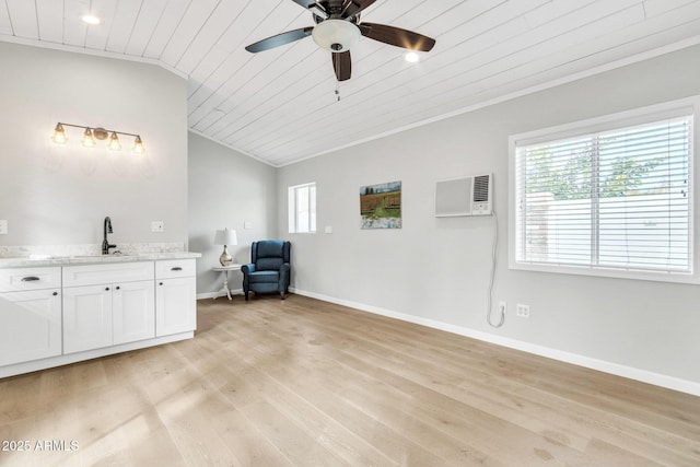 unfurnished room featuring an AC wall unit, wood ceiling, lofted ceiling, ceiling fan, and sink