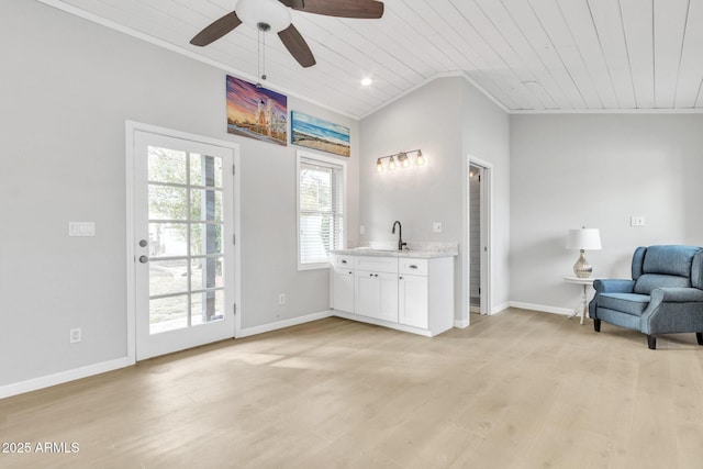 interior space with vaulted ceiling, light wood-type flooring, crown molding, ceiling fan, and wooden ceiling