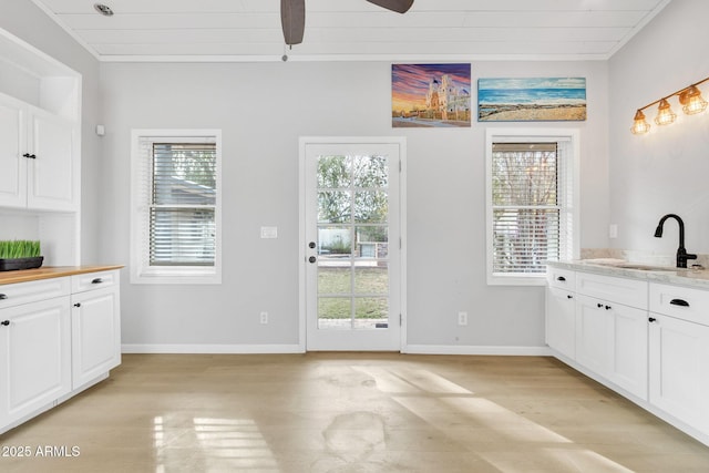 doorway to outside with plenty of natural light, light hardwood / wood-style flooring, and sink