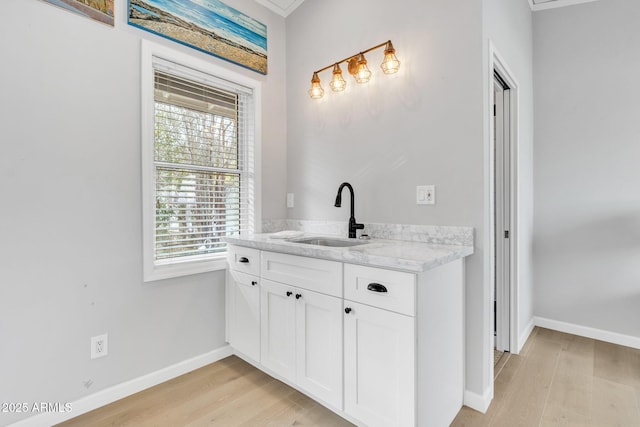 bathroom featuring vanity, hardwood / wood-style flooring, and plenty of natural light