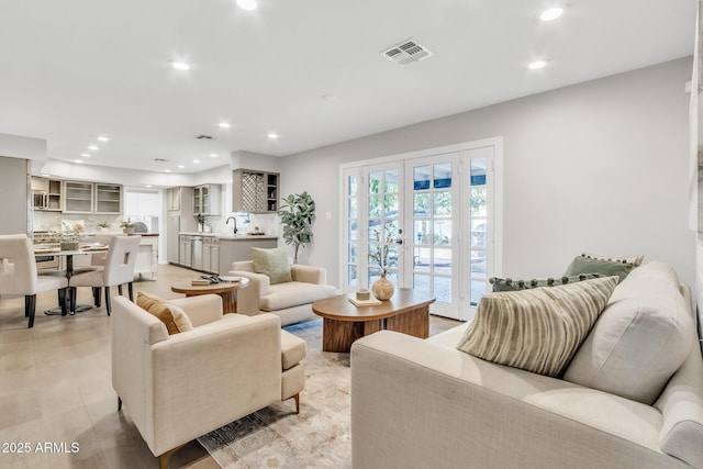 living room featuring french doors and sink