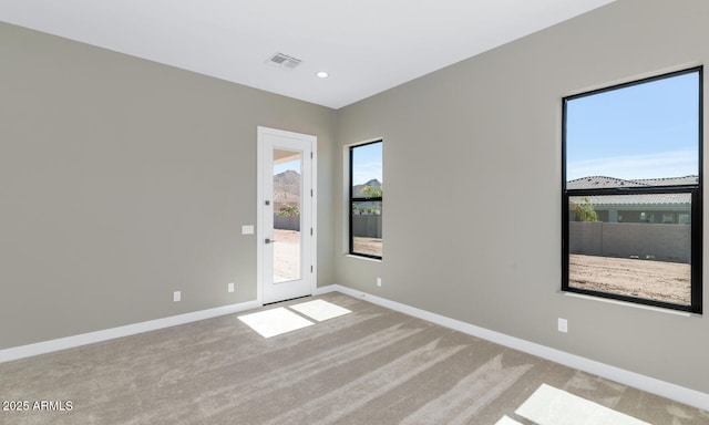 carpeted empty room with recessed lighting, baseboards, and visible vents