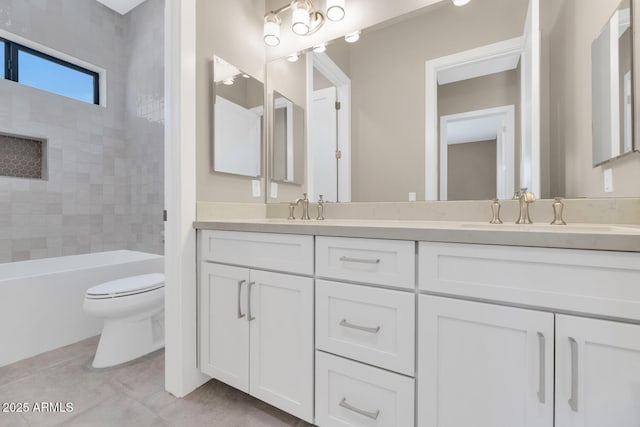 bathroom with a sink, toilet, double vanity, and tile patterned flooring