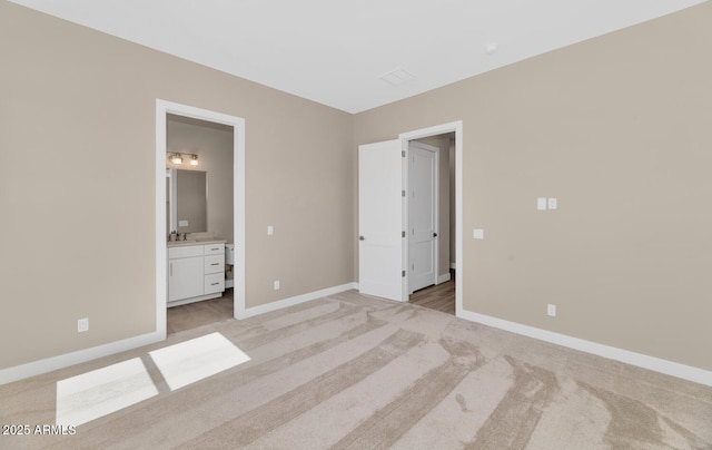 unfurnished bedroom with baseboards and light carpet