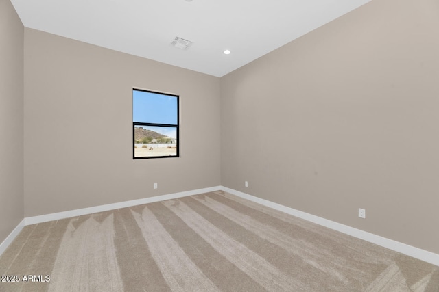 unfurnished room featuring light colored carpet, baseboards, and visible vents