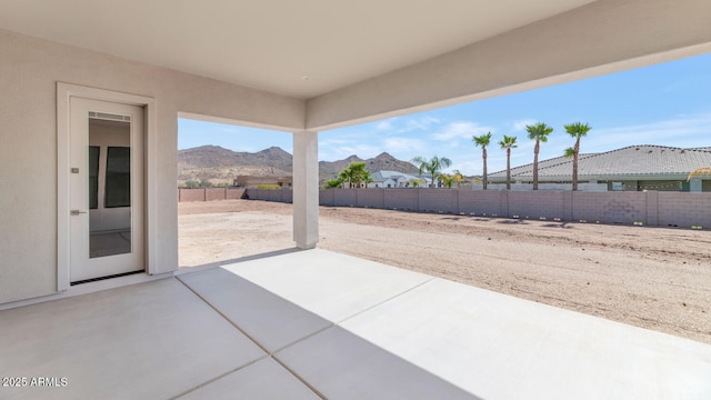 view of patio featuring a fenced backyard and a mountain view