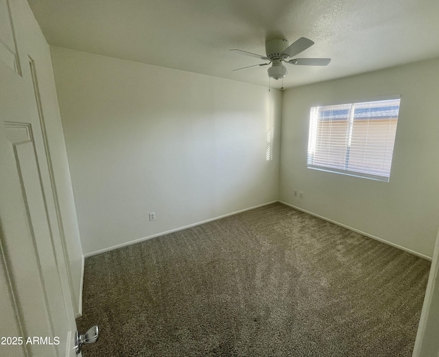 empty room with baseboards, a ceiling fan, and carpet floors