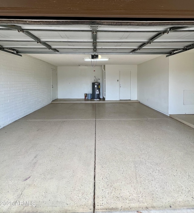 garage featuring water heater and a garage door opener