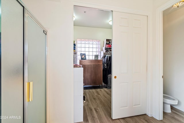 hallway with light hardwood / wood-style floors