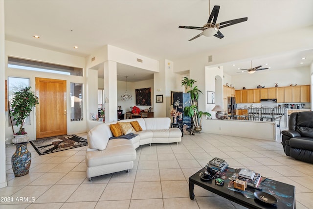 living room with ceiling fan and light tile patterned floors