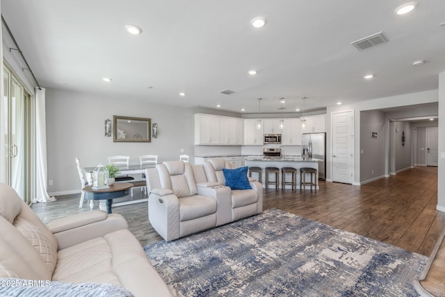 9757 E Red Giant Dr, Mesa, AZ 85212 - living room with baseboards, dark wood-style flooring, and recessed lighting
