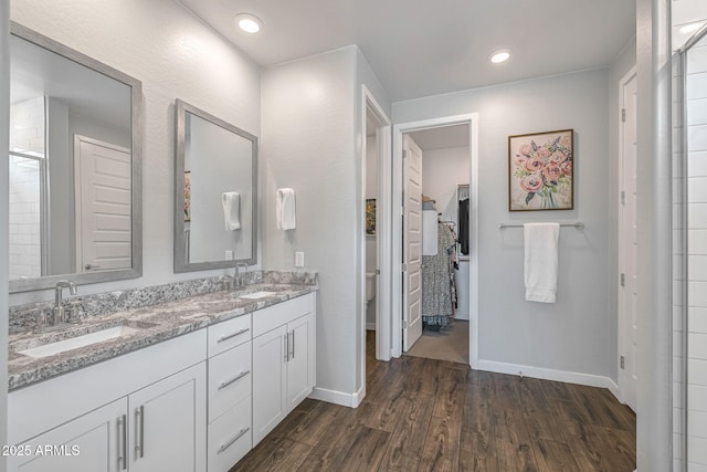 9757 E Red Giant Dr, Mesa, AZ 85212 - bathroom with toilet, double vanity, wood finished floors, baseboards, and a walk in closet