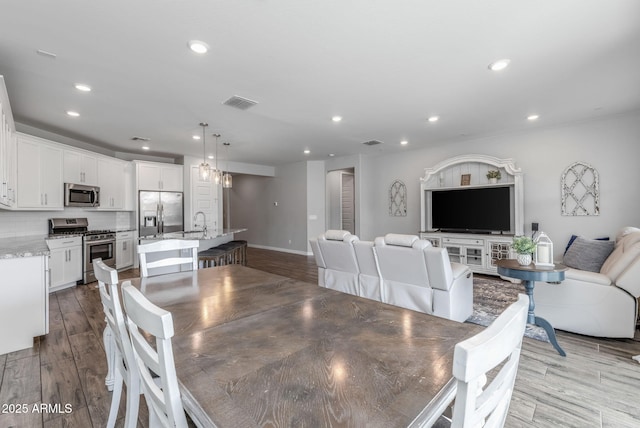 9757 E Red Giant Dr, Mesa, AZ 85212 - dining room featuring recessed lighting, wood finished floors, and baseboards