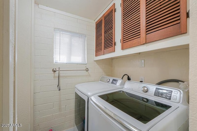 washroom with cabinets and separate washer and dryer