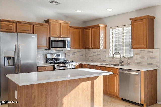 kitchen featuring light tile patterned floors, backsplash, appliances with stainless steel finishes, and sink