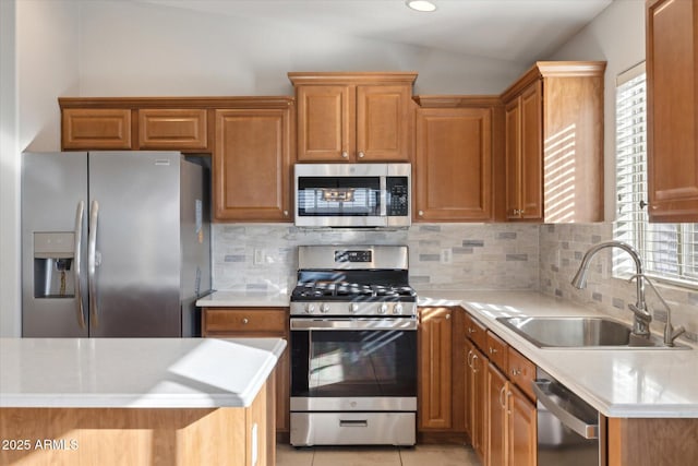kitchen with backsplash, vaulted ceiling, sink, stainless steel appliances, and light tile patterned floors