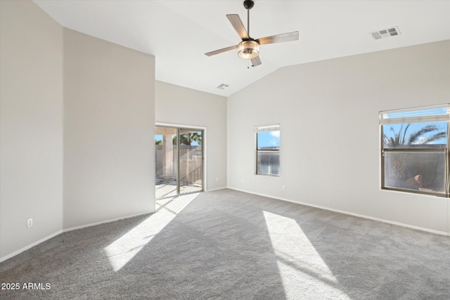 carpeted empty room featuring ceiling fan and high vaulted ceiling