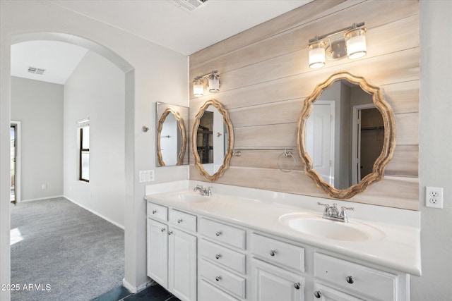 bathroom featuring wood walls and vanity