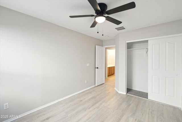 unfurnished bedroom with ceiling fan, light hardwood / wood-style floors, and a closet