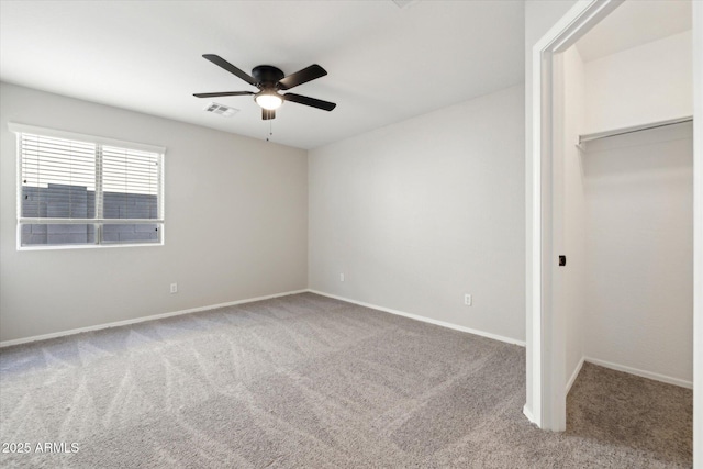 unfurnished bedroom with ceiling fan, a closet, and carpet floors