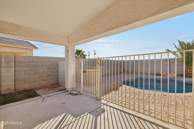 view of patio / terrace with a fenced in pool