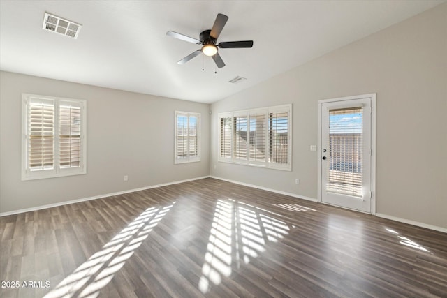 empty room with ceiling fan, dark hardwood / wood-style flooring, and lofted ceiling