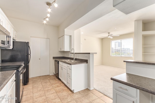 kitchen featuring ceiling fan, sink, light carpet, white cabinets, and appliances with stainless steel finishes