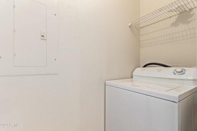 washroom featuring electric panel and washer / dryer