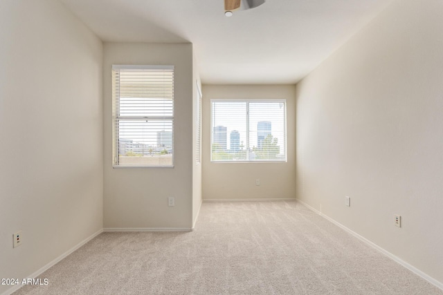 carpeted spare room with plenty of natural light