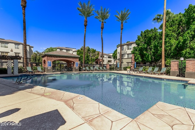 view of swimming pool featuring a gazebo and a patio area