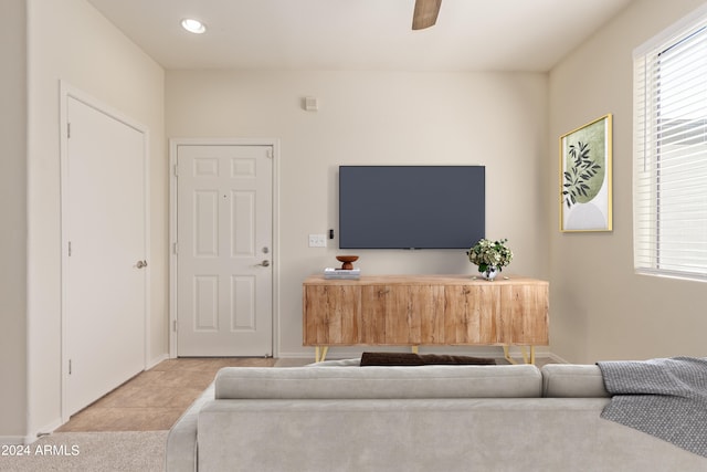 tiled living room featuring ceiling fan