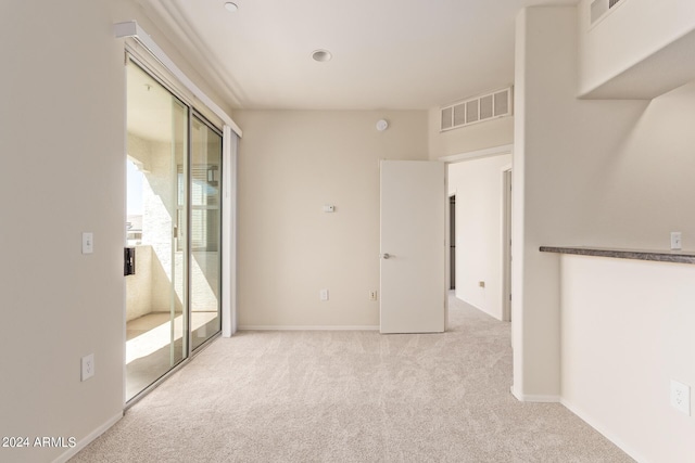 spare room with light colored carpet