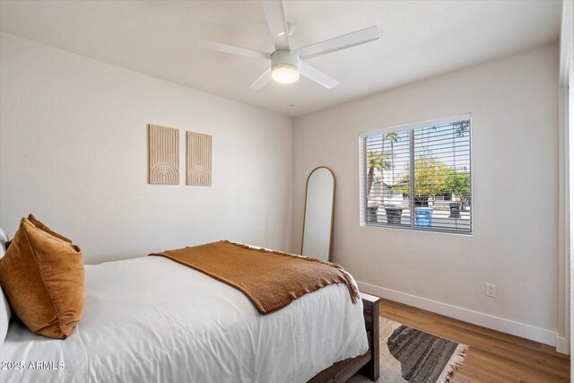 6271 E Evans Dr, Scottsdale, AZ 85254 - bedroom with wood finished floors, baseboards, and a ceiling fan
