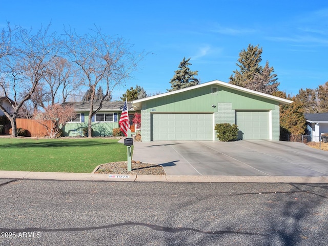 ranch-style home with a garage and a front yard