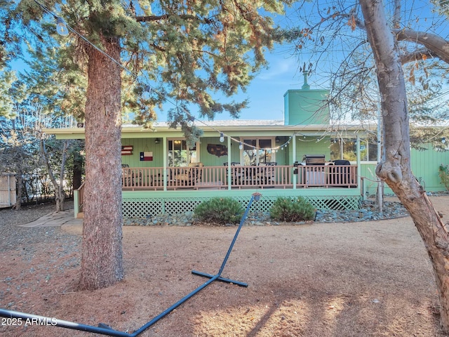 back of house featuring a deck