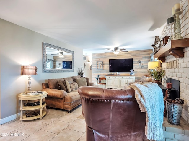 tiled living room featuring ceiling fan and wooden walls