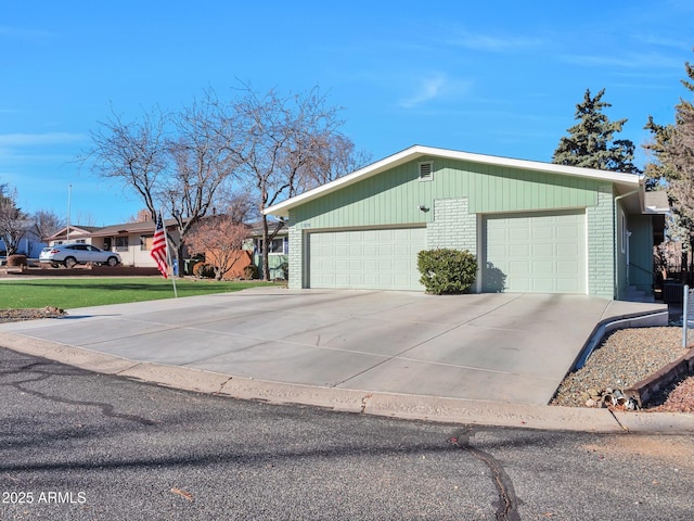 view of side of home featuring a garage and a yard