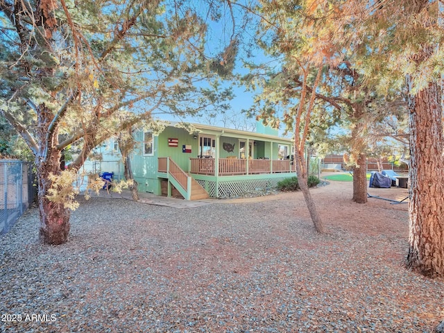 back of house featuring covered porch