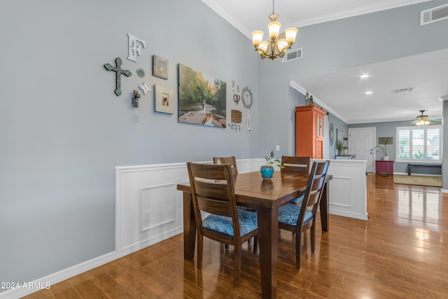 dining room with wood finished floors, visible vents, and crown molding