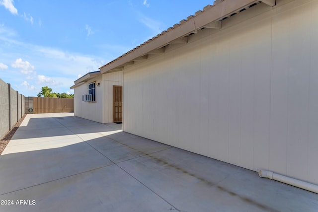 view of side of home with a patio area and a fenced backyard