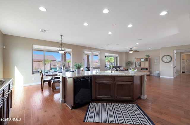 kitchen with light wood-type flooring, a sink, dishwasher, and open floor plan